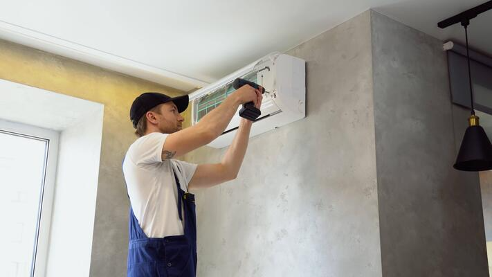 young-worker-in-uniform-installs